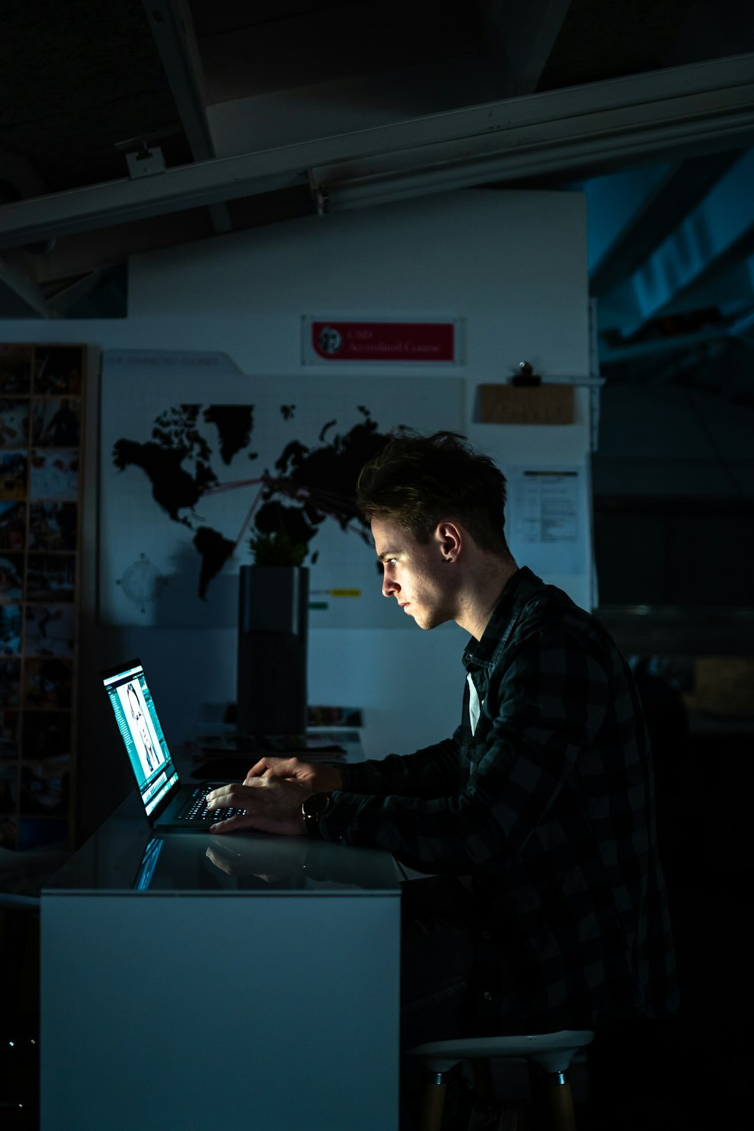 author writing on laptop at night