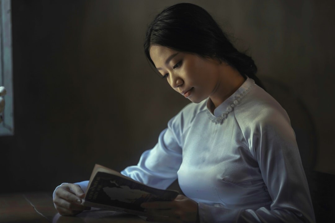 woman reading book in dim light
